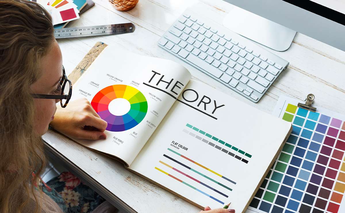 Una donna consulta un libro sulla teoria del colore